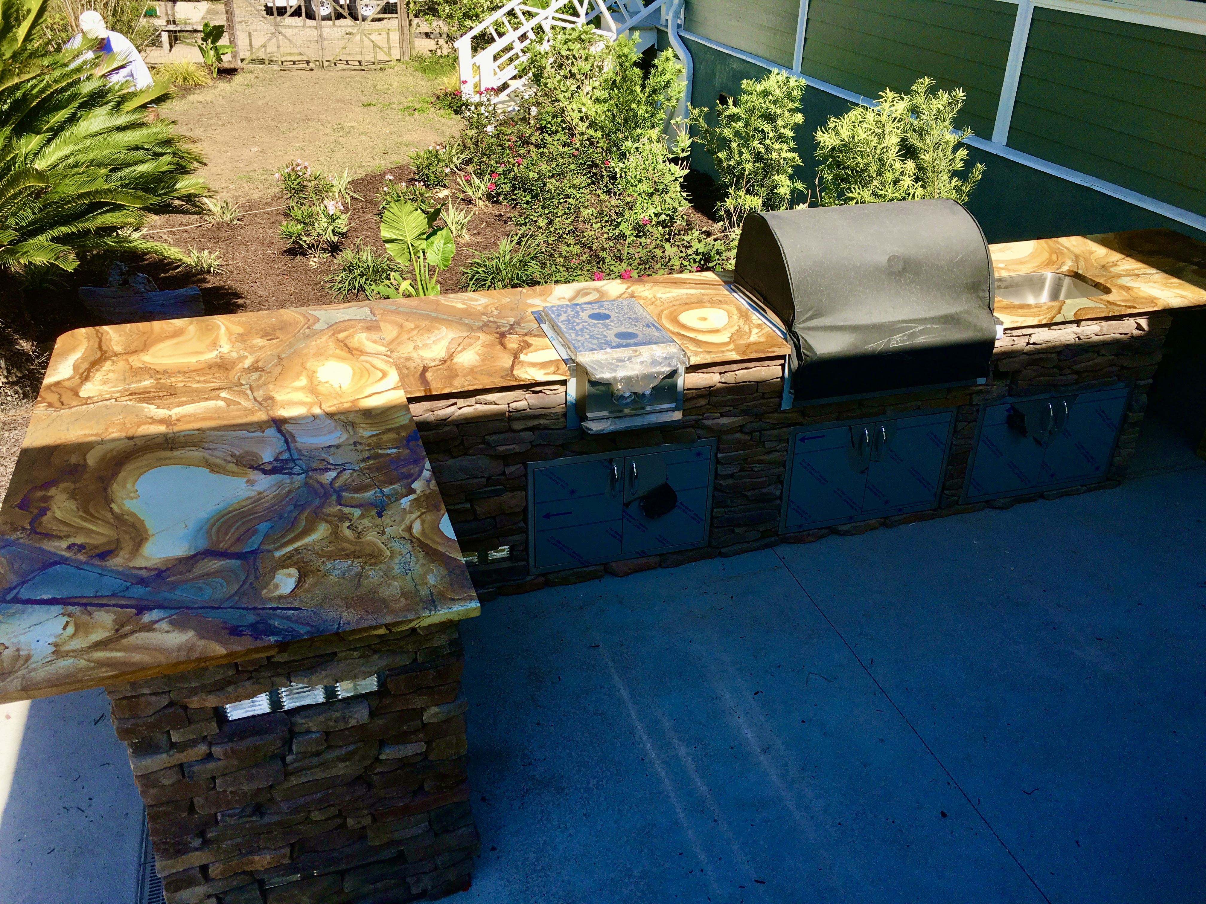Outdoor kitchen with custom marble countertop and stainless appliances